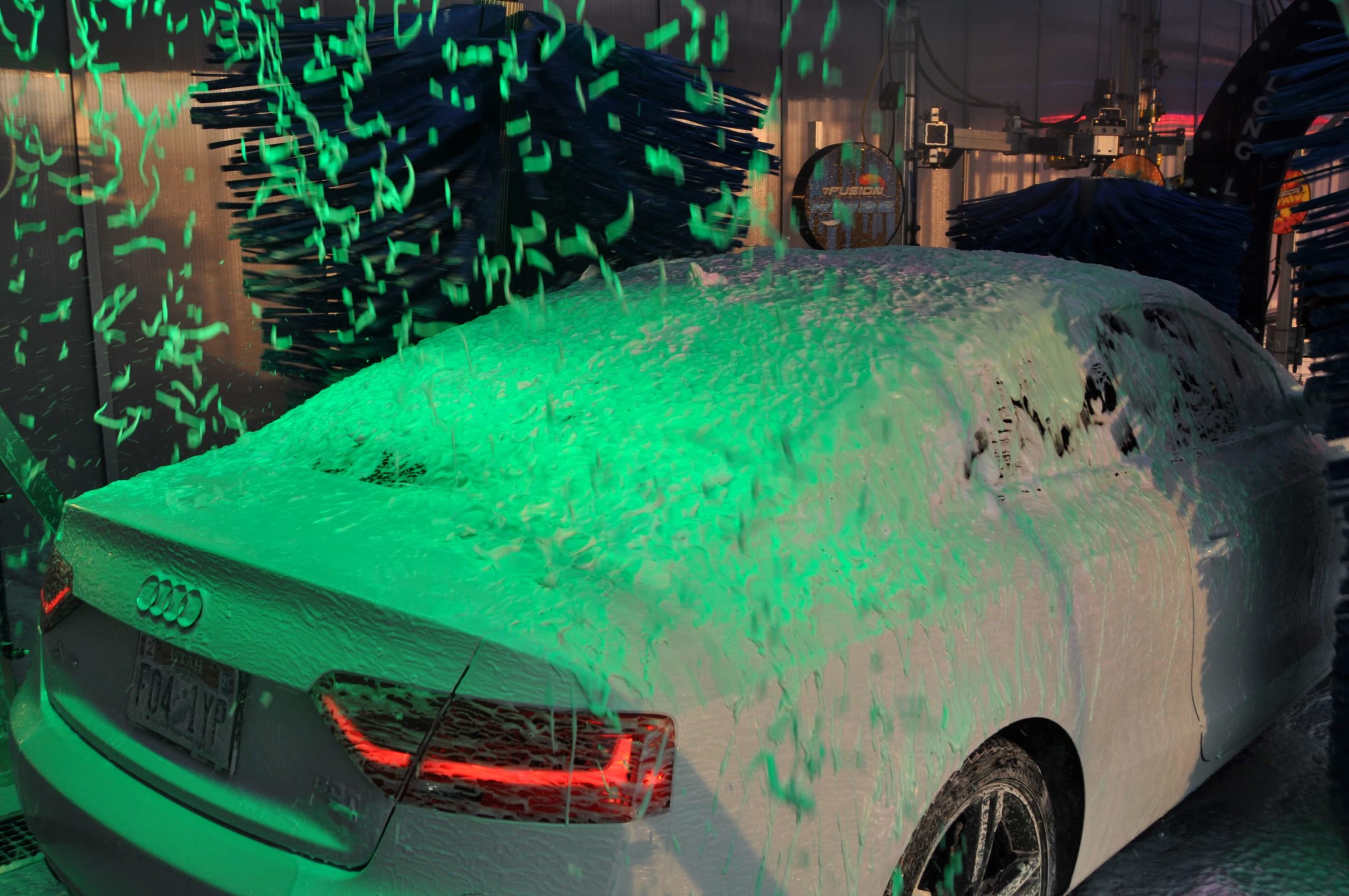Car inside of tunnel covered in green foam
