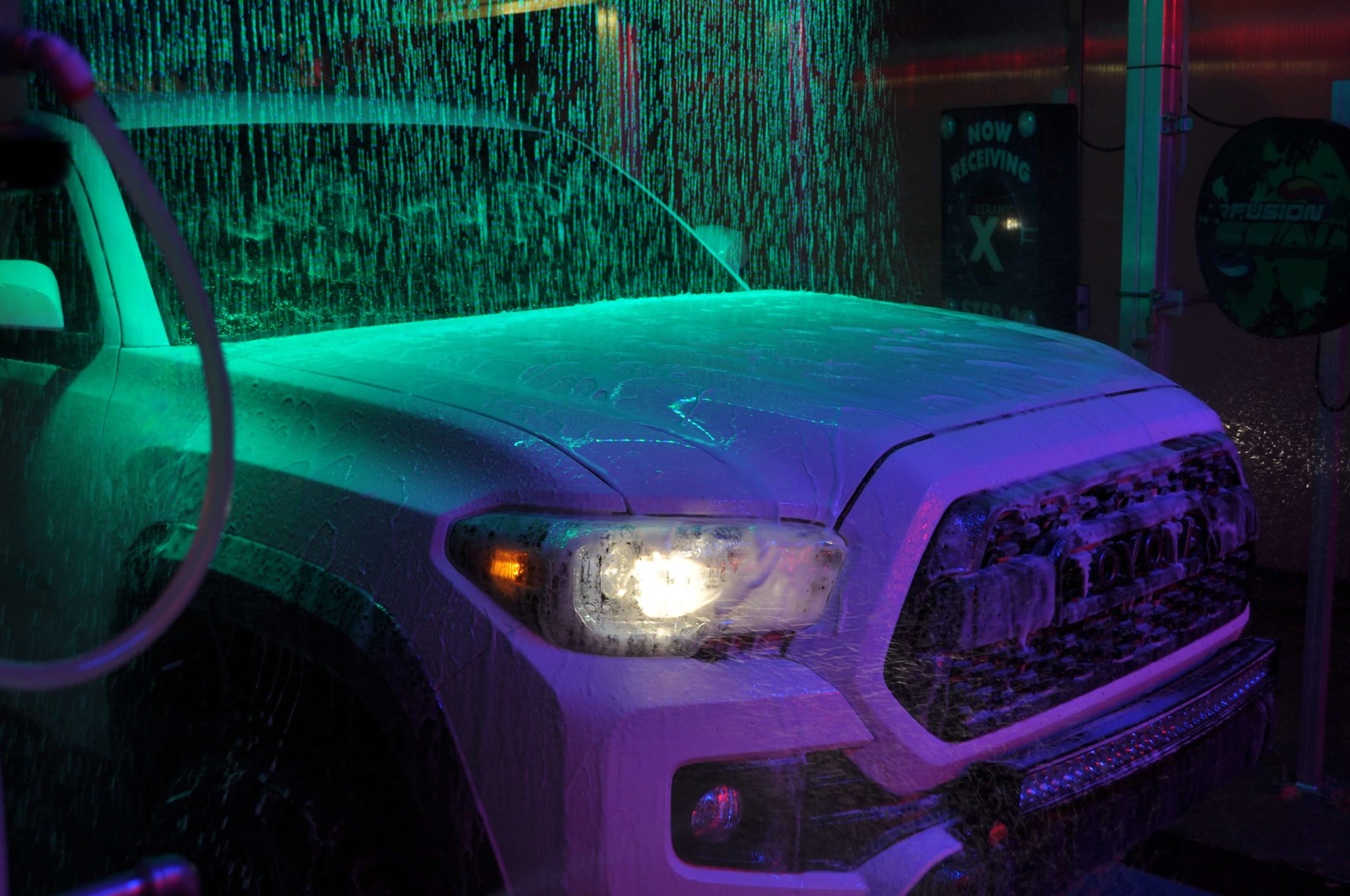 Car inside of tunnel with suds covering the car